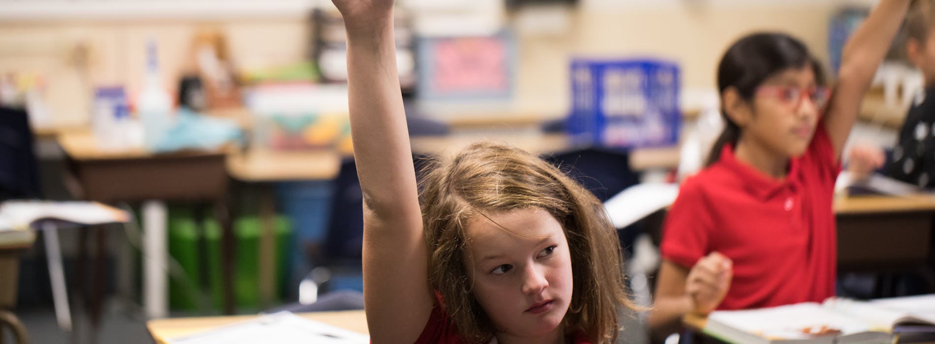  Payette Students raising their hands in class. 
