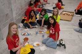 Charter school students eating pizza