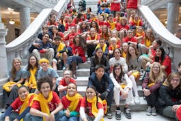 Dozens of students sit on state capitol steps