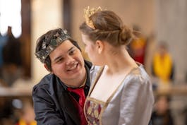 Male and female student acting out Shakespeare in costume