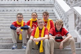 Charter school students sitting on capitol rotunda steps