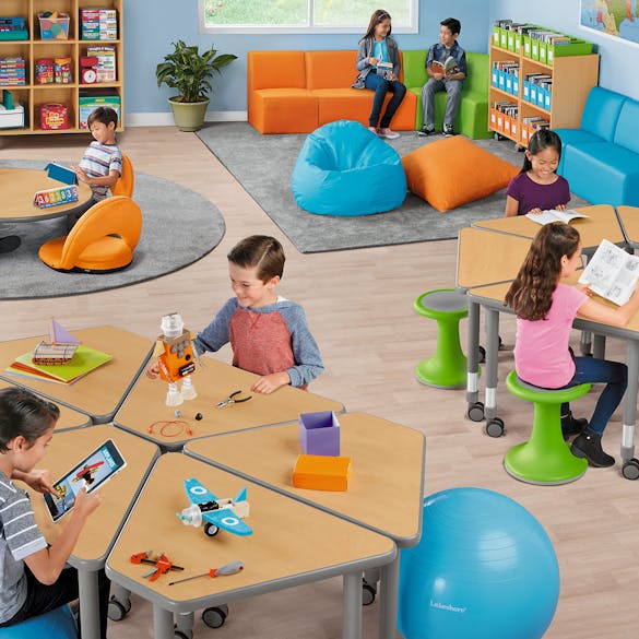  Students sitting on various flexible seating furniture 