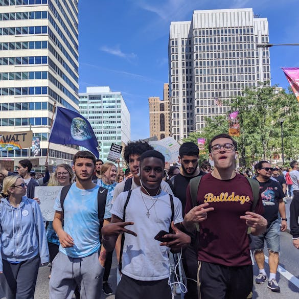  Male students walking at a rally outdoors 