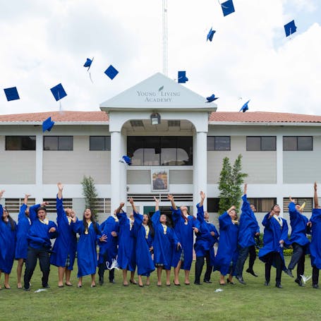 Young Living Foundation - Our Story - Young living Academy graduates toss their caps 